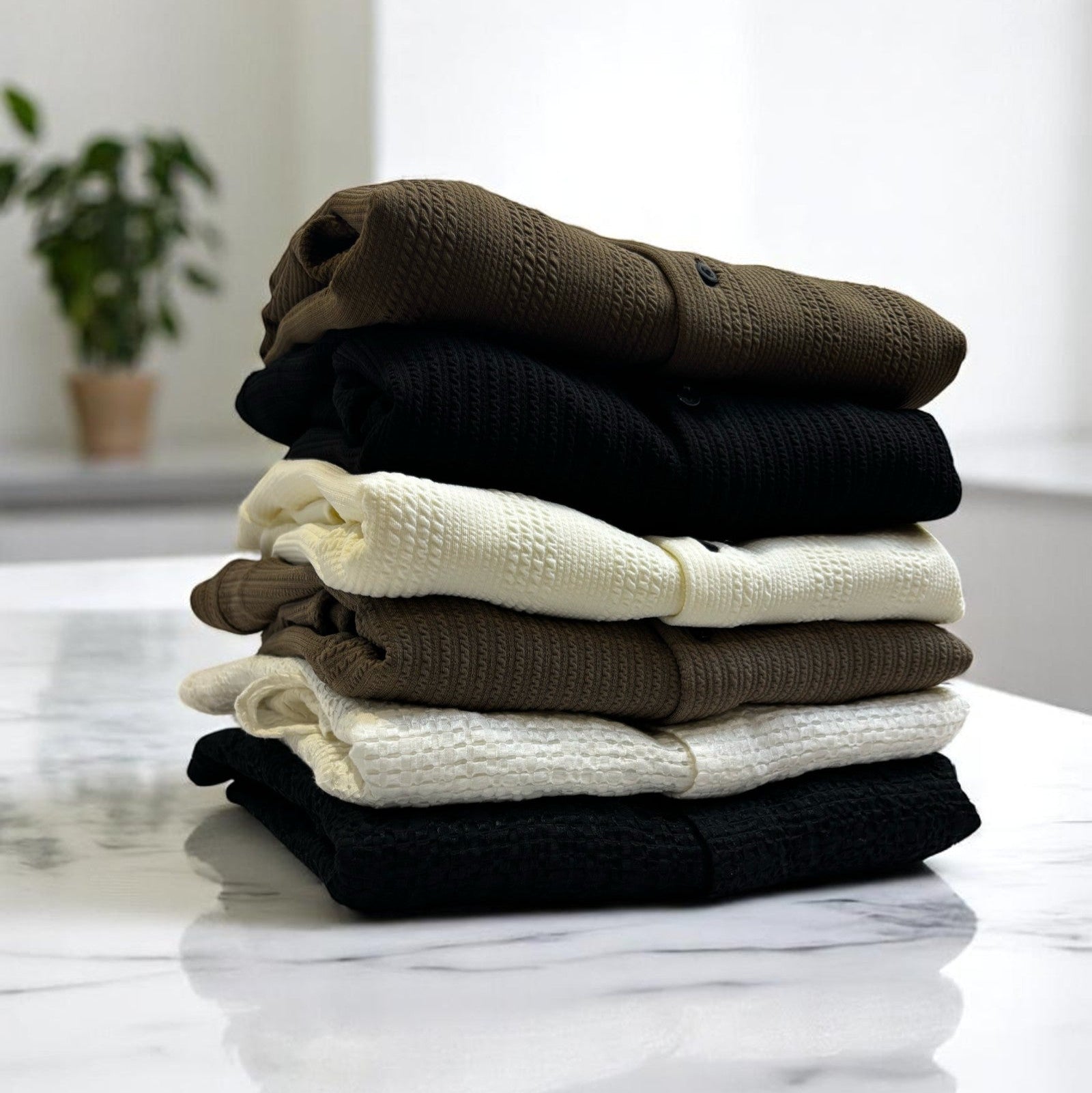 six folded shirts on countertop