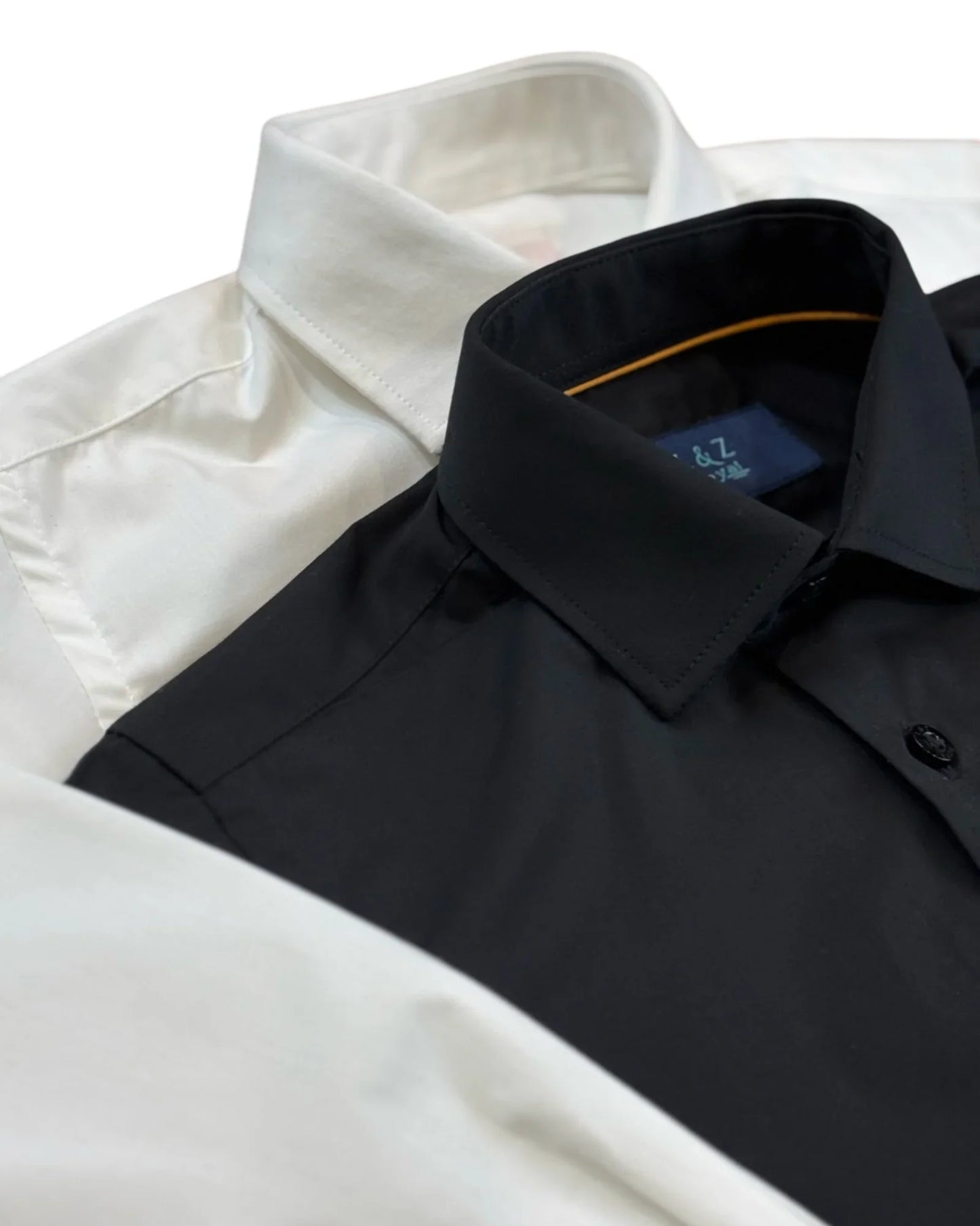 Close up of boys lack and white dress shirt. featuring the collar and top buttons.