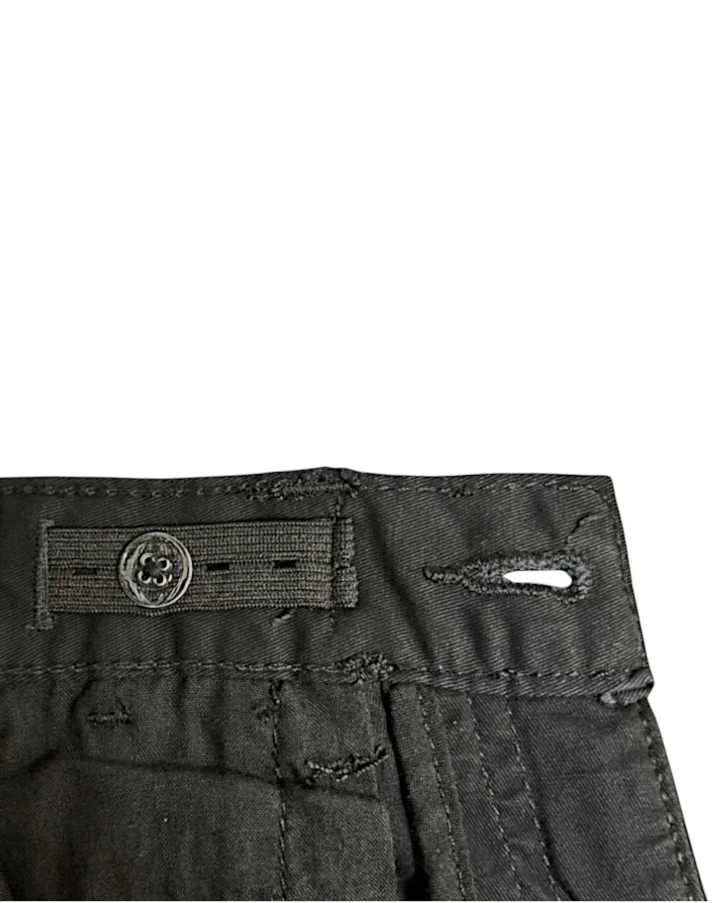 Close-up of black pants with adjustable elastic on inner waistband.