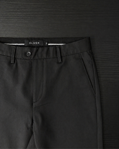 Boys black stretch dress pants waistband close up button and belt loops detail