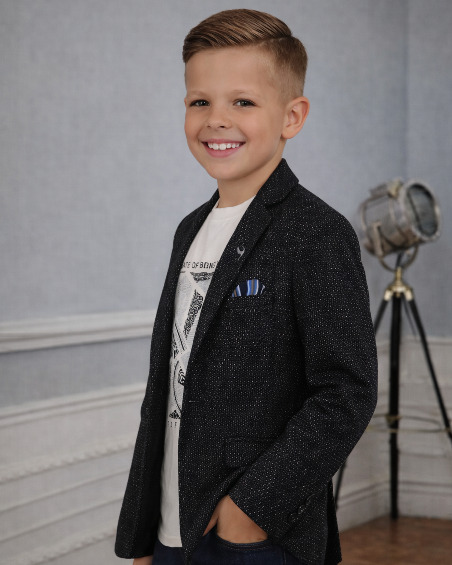 Side view of boys black textured blazer showing slim fit and shimmer jacquard pattern for party outfits