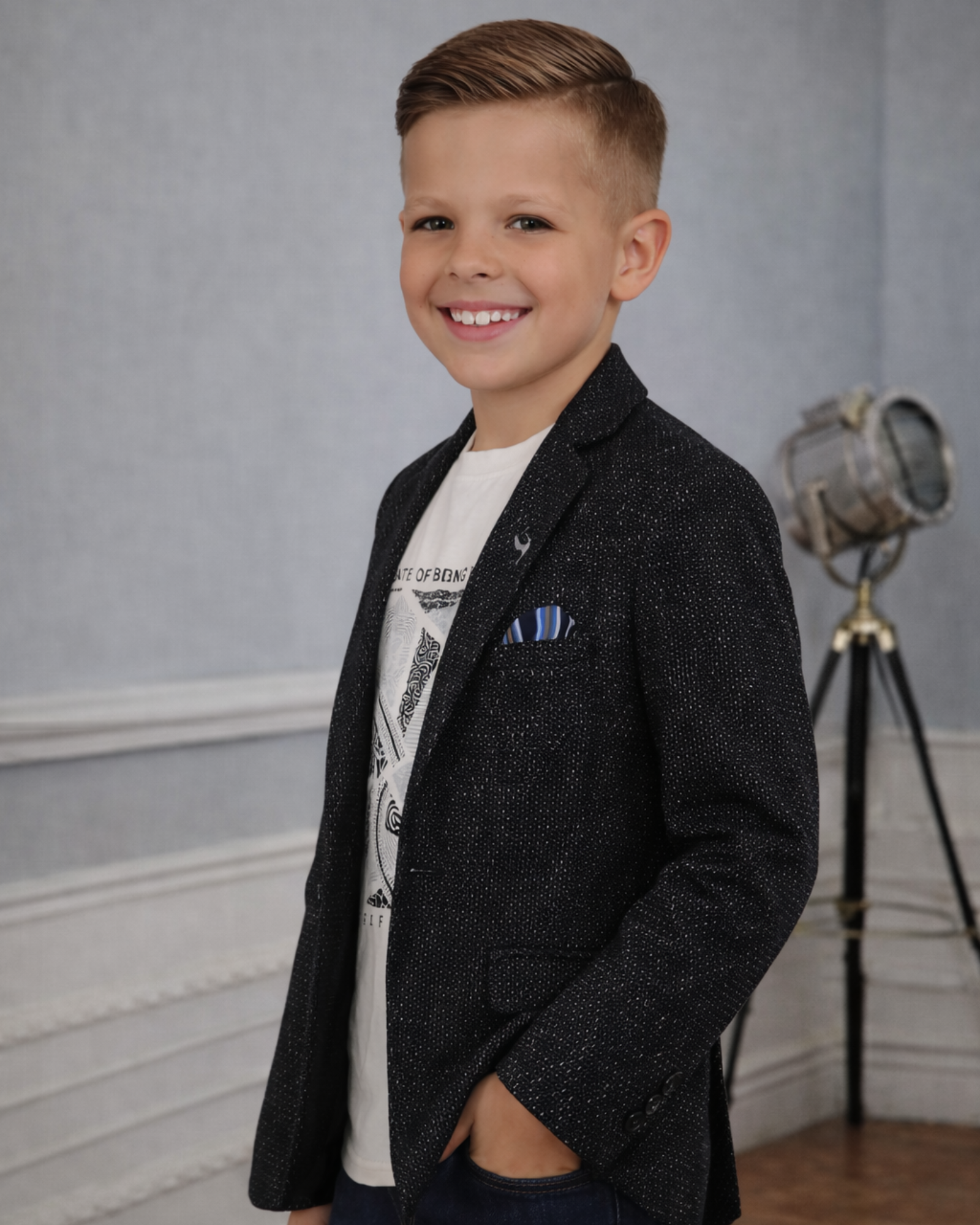 Side view of boys black textured blazer showing slim fit and shimmer jacquard pattern for party outfits