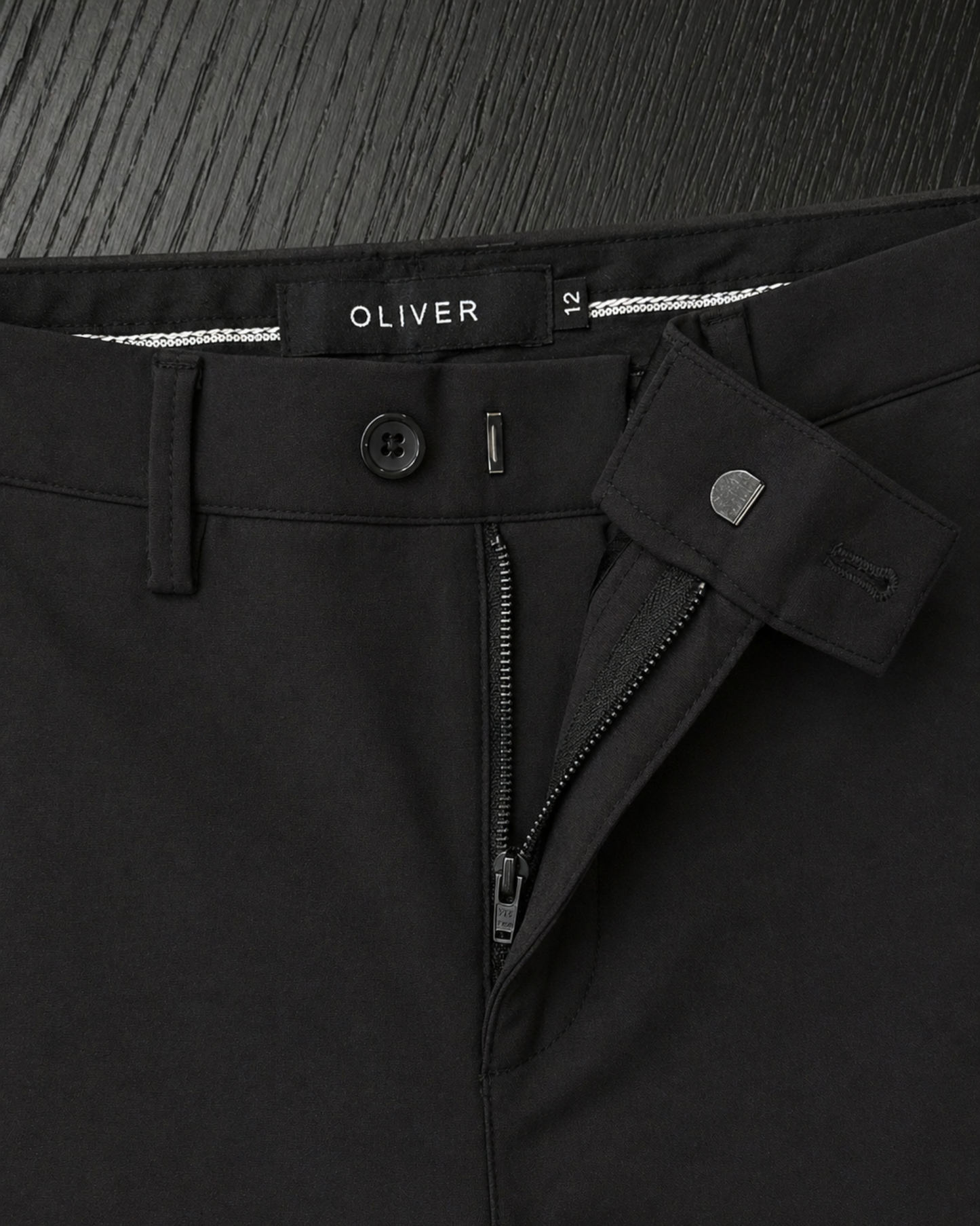 Boys black stretch dress pants zipper and hook closure close up detail