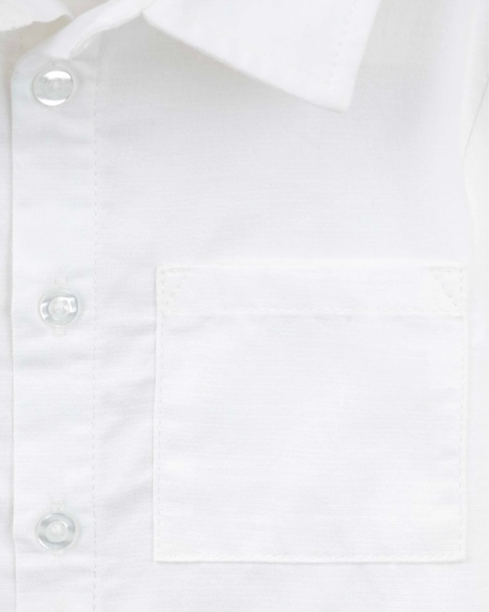Close-up of a white long-sleeve button-down shirt showing the collar, front button placket, and a chest pocket.