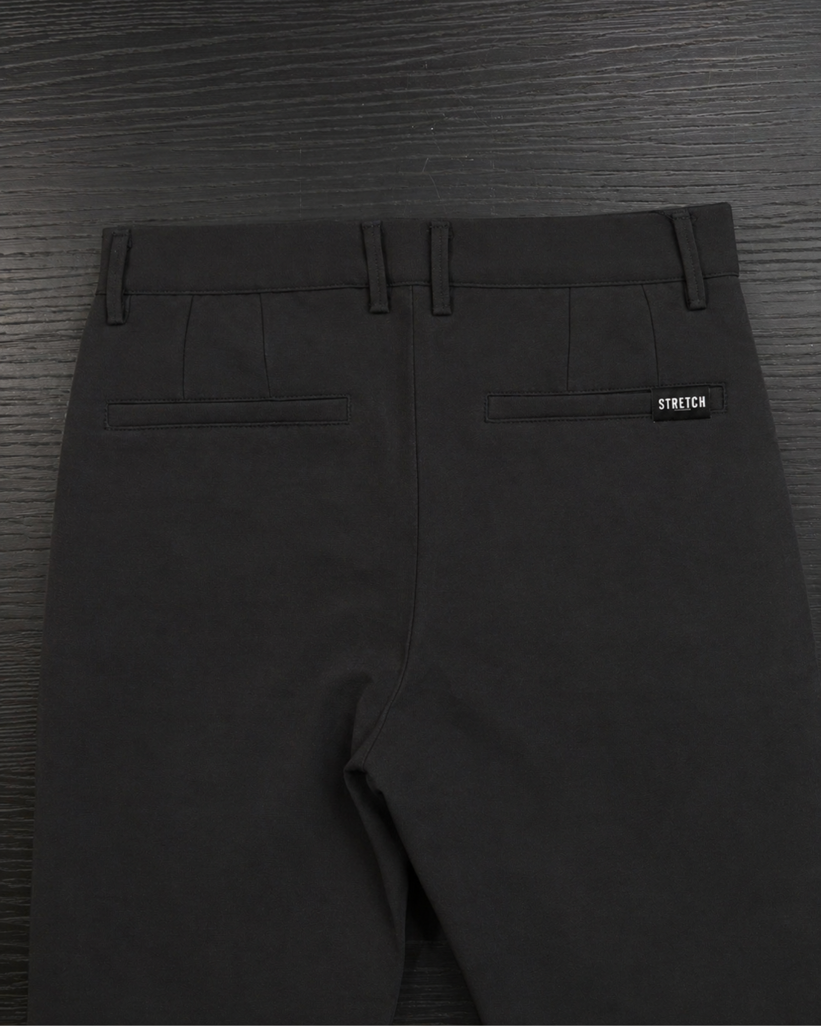 Boys black stretch dress pants back view with pockets and stretch label
