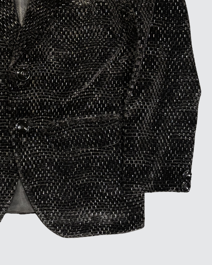 Detailed view of black textured jacquard blazer fabric with subtle shimmer pattern for boys party wear