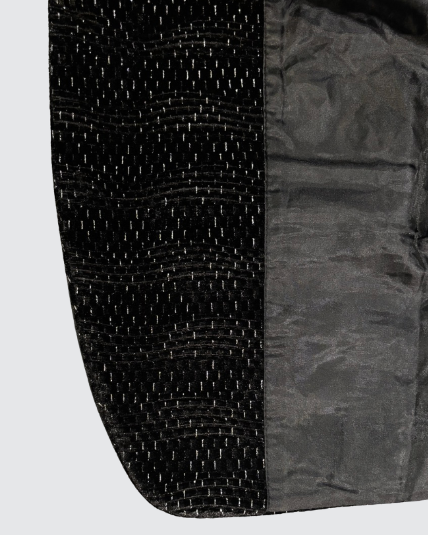 Inner lining and textured outer fabric of boys black blazer showing quality finish and structure