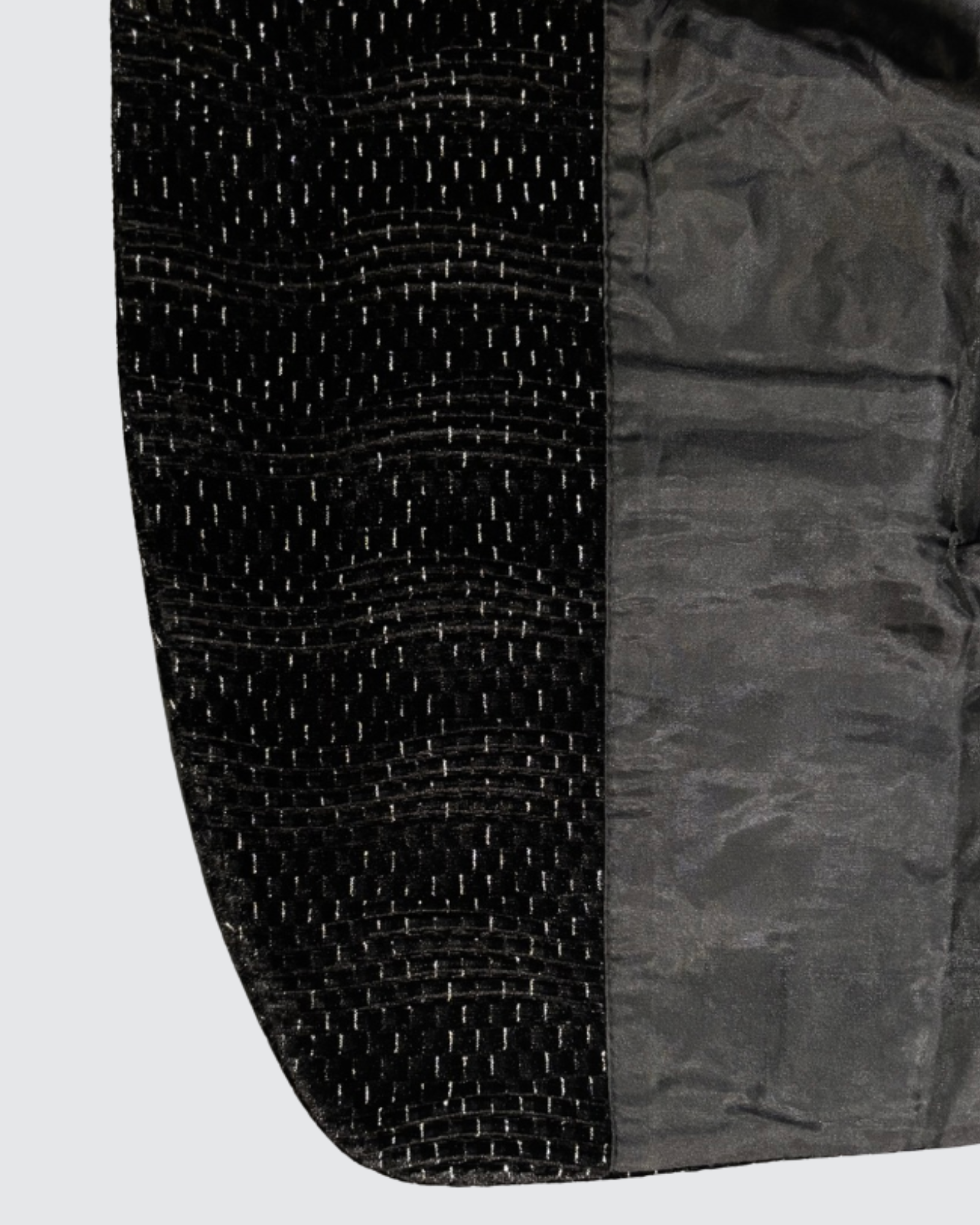 Inner lining and textured outer fabric of boys black blazer showing quality finish and structure