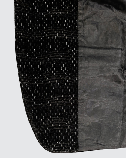 Inner lining and textured outer fabric of boys black blazer showing quality finish and structure