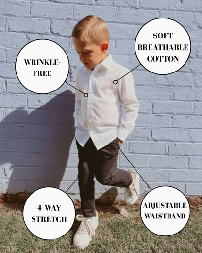 Boy wearing white dress shirt and black stretch chinos for boys with features including wrinkle-free fabric, breathable cotton, 4-way stretch and adjustable waistband.