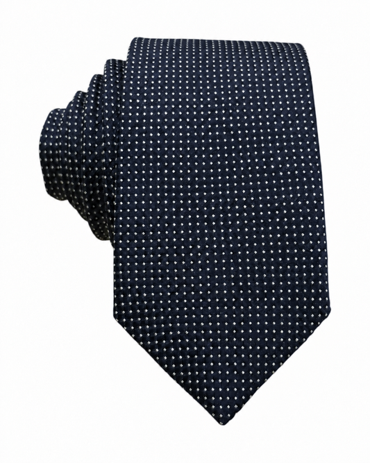 A dark navy blue necktie with a small white polka dot pattern, shown folded on a plain white background.