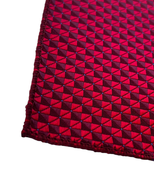 Close-up of a red pocket square with a geometric design on a white background