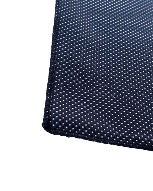 Close up of Black pocket square with a subtle pattern on a white background