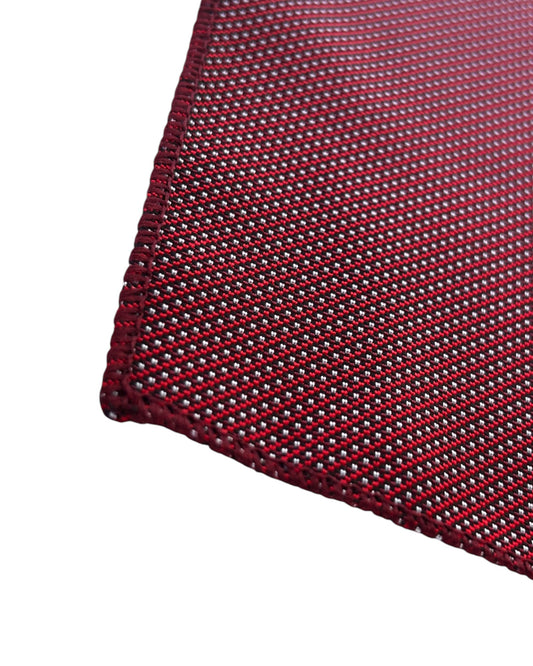 Close-up of a red with white polka dot pocket square on a white background