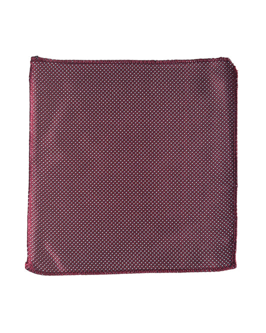 Red with white polka dot pocket square on a white background