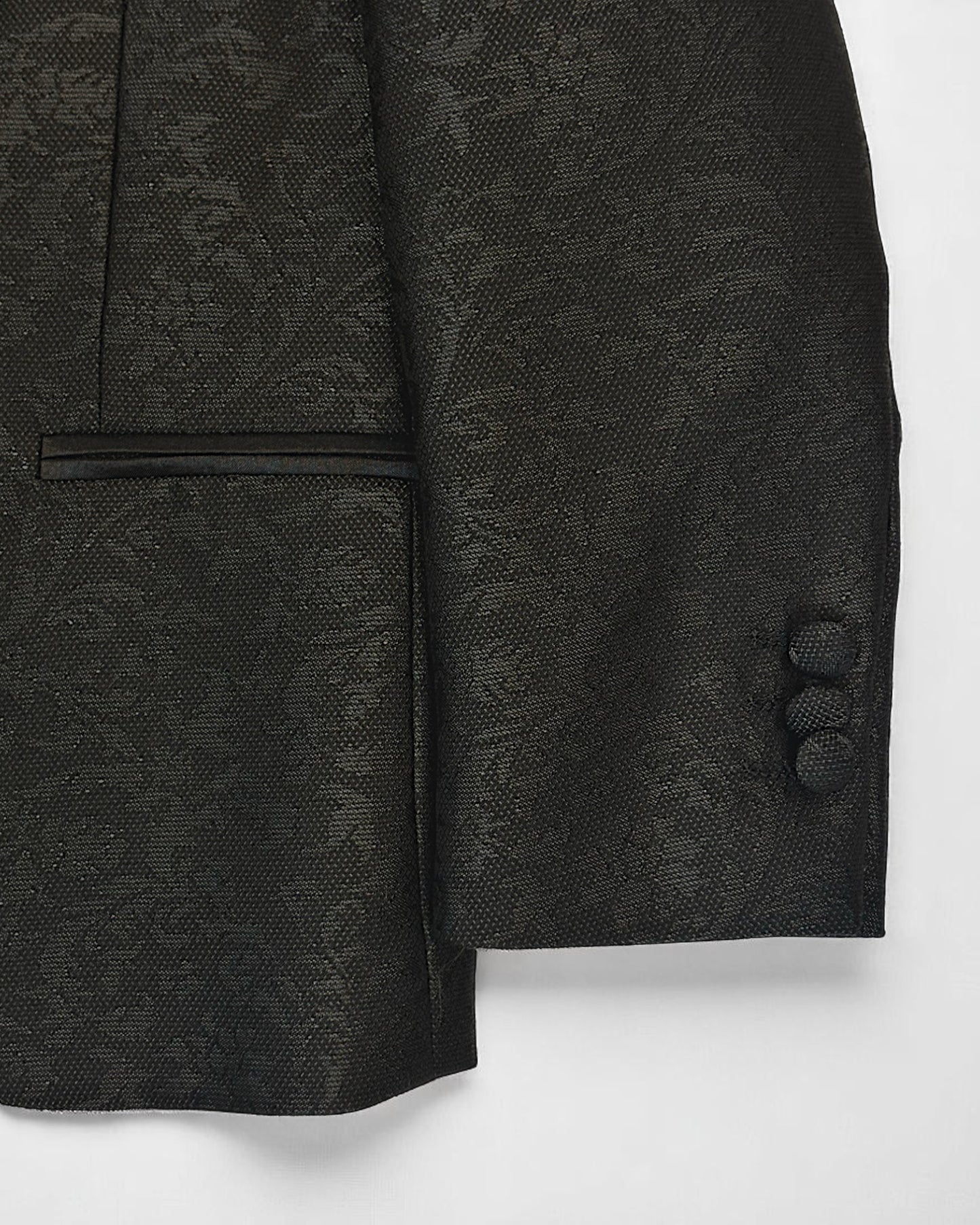 flat lay of sleeve of black kids jacquard blazer
