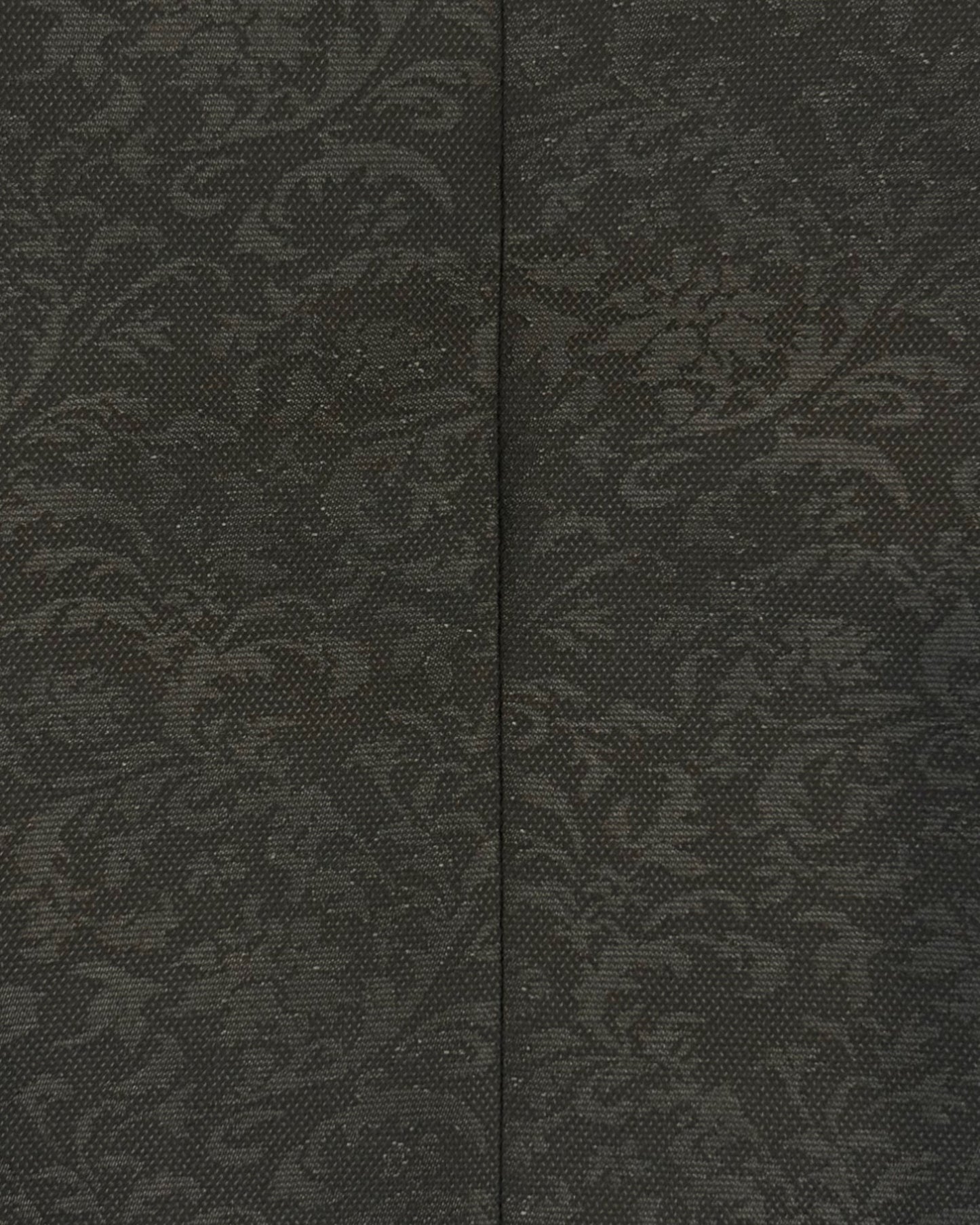 extreme close up of flat lay of black kids jacquard blazer