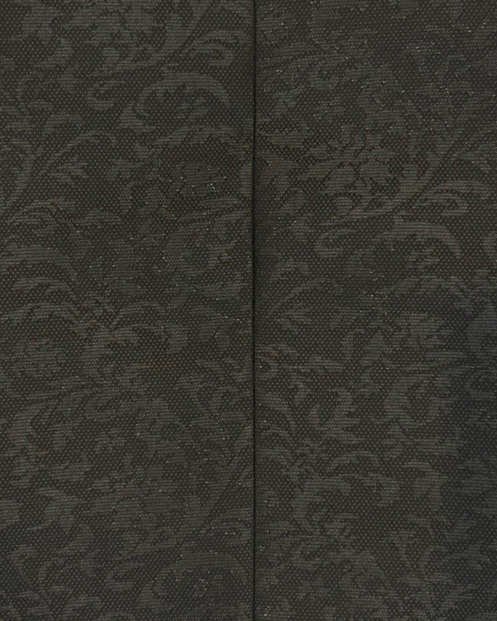 extreme close up of flat lay of black kids jacquard blazer