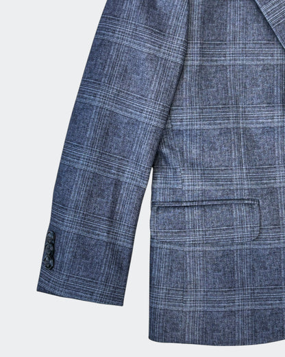 close up of right side of the blazer, highlighting the sleeve, pocket, and three button design on the sleeve.