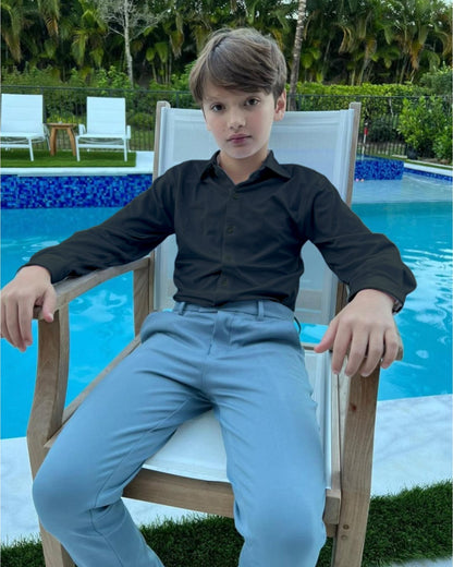 boy in black dress shirt sitting on chair