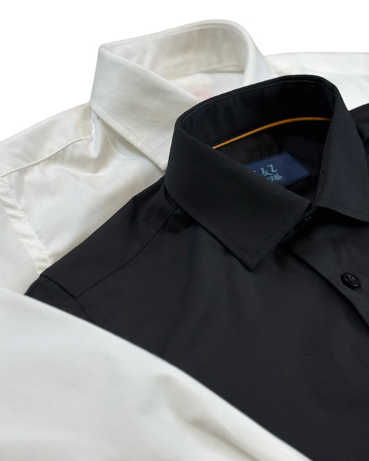 Close up of boys lack and white dress shirt. featuring the collar and top buttons.
