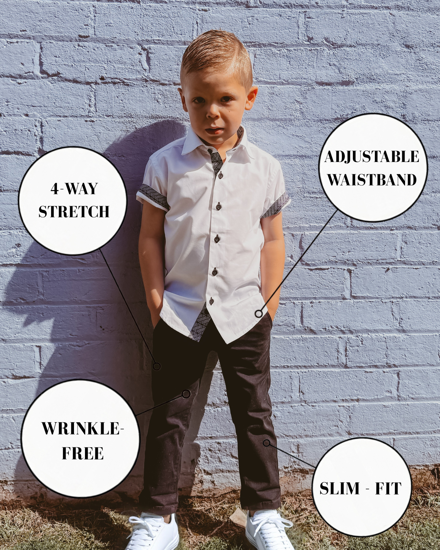 Boy wearing white dress shirt and black stretch chinos with feature callouts including 4-way stretch, adjustable waistband, wrinkle-free fabric, and slim fit.