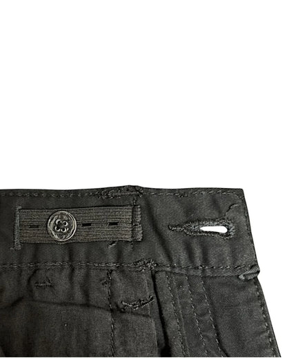 Close-up of black pants with adjustable elastic on inner waistband.