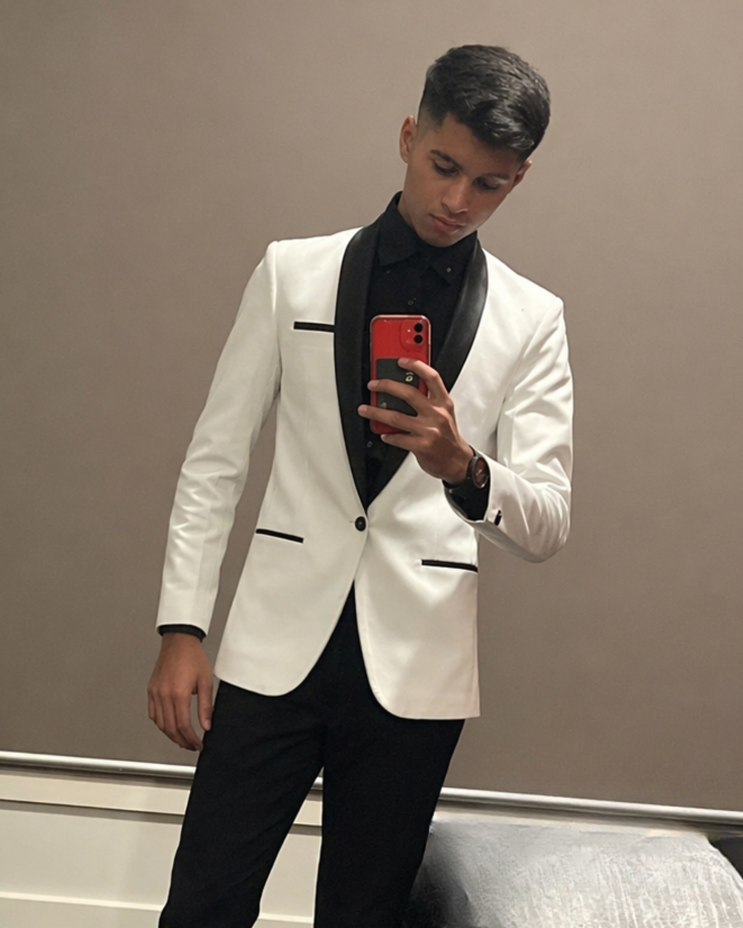 Boy wearing white velvet blazer with black lapel for formal event