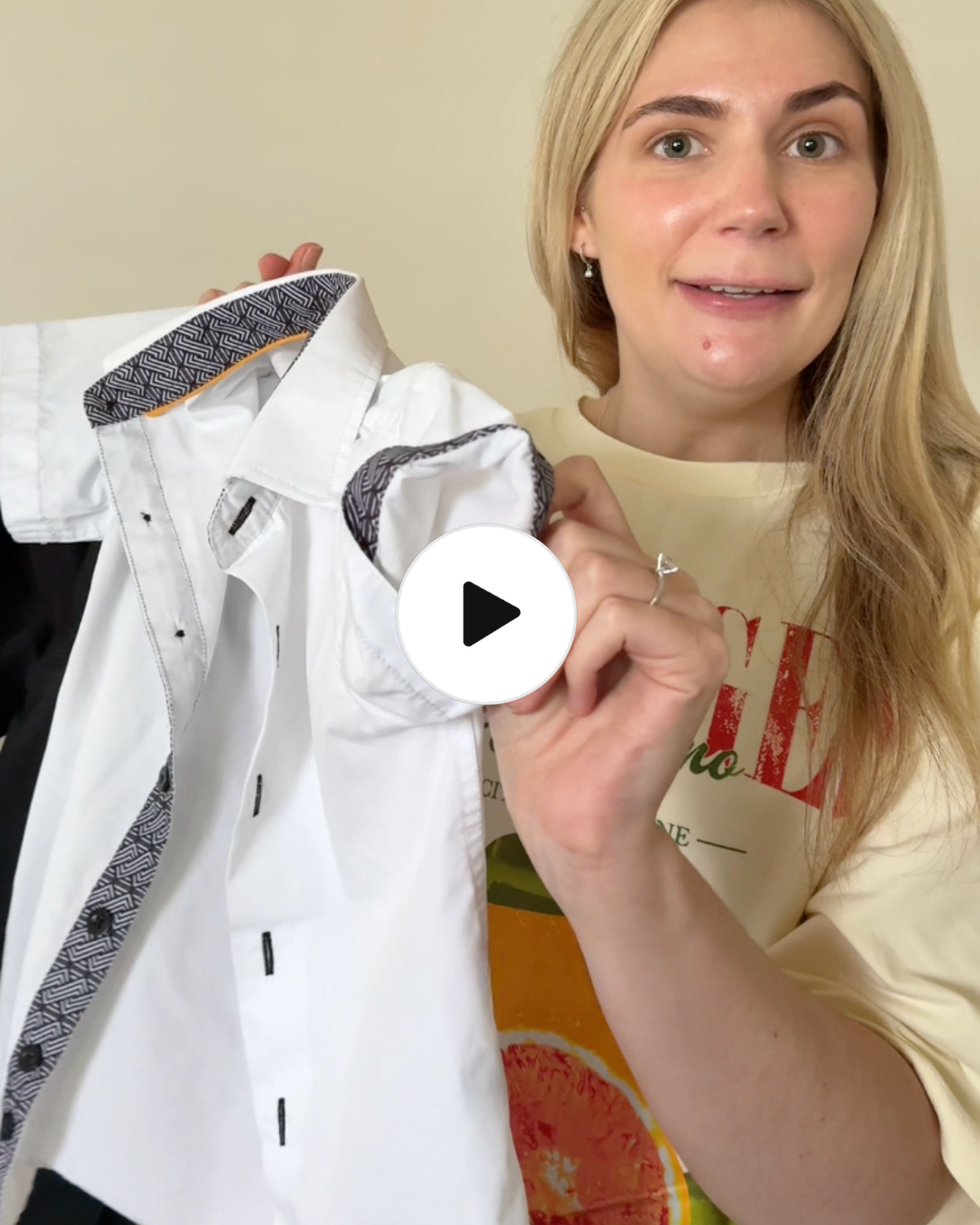 Mum talking about kids white short sleeves shirt, and giving her opinion on it as well as describing features, and details.