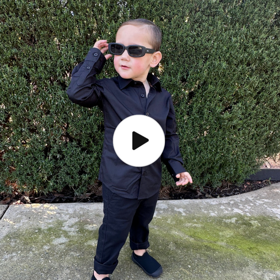 young boy wearing black shirt and black chinos running in  4 different areas