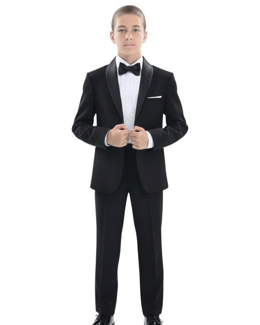 teenager in a black tuxedo. shawl lapel jacket and dress pants.